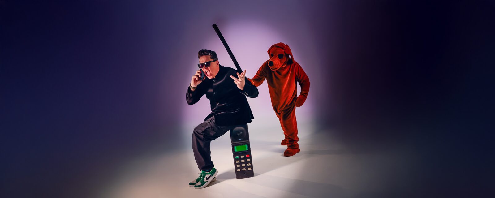 Dom Jolly being bopped on the head by a giant dog