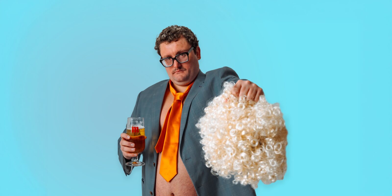 Sandro Ford poses with a wig and pint of beer - banner